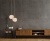 Dwie-lampy-wiszace-Stones-25-cm-w-salonie-na-tle-betonowej-sciany.jpg