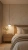 Biała lampa wisząca nad szafką nocną w sypialni